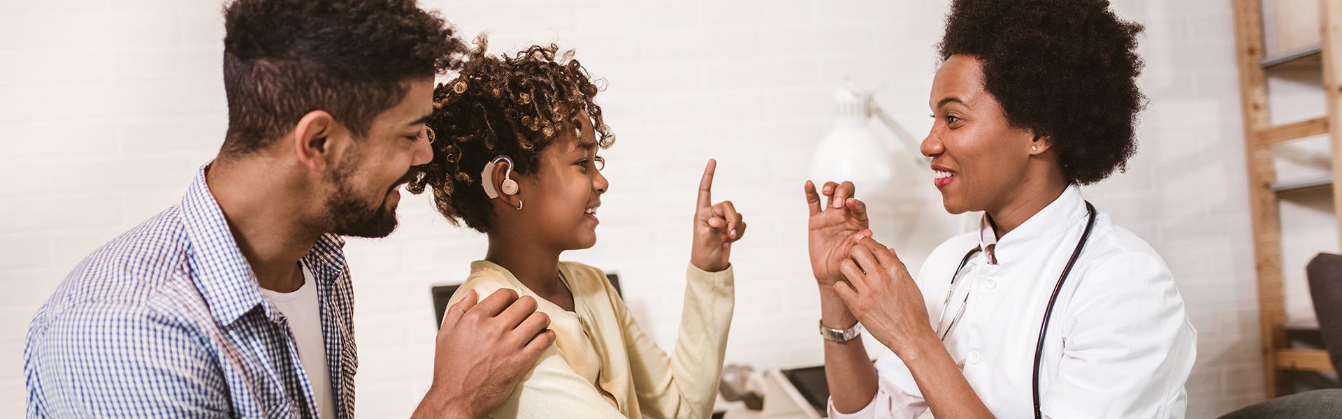 A father and daughter attending American Sign Language lesson