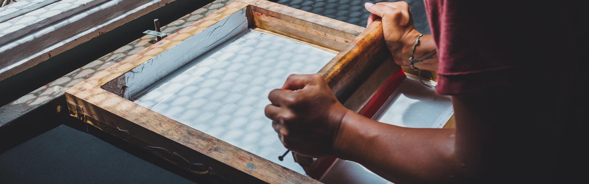 A person doing screen printing 