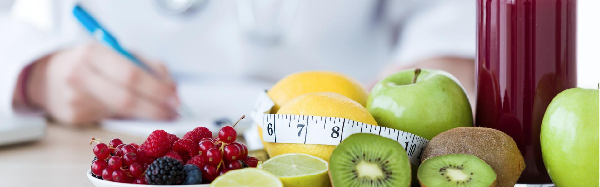 Nutritionist desk with fruit and measuring tape