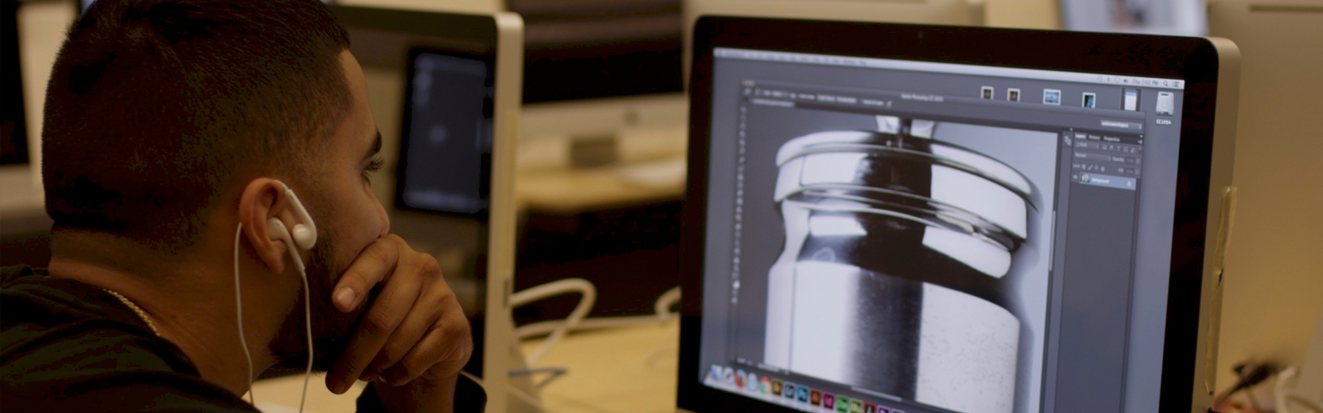 A student looking at a 3D model on a computer screen.