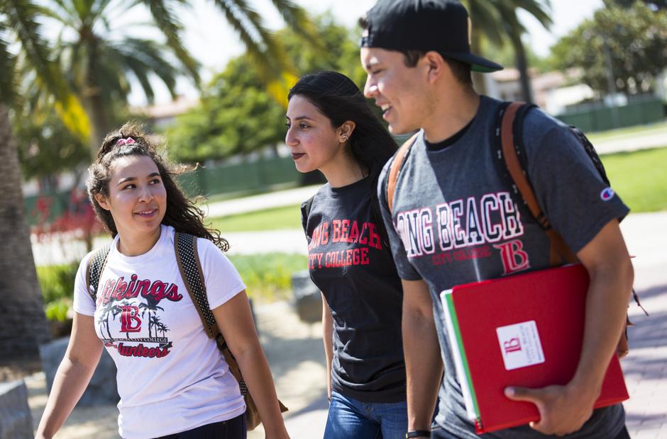 Three students walking through campus.