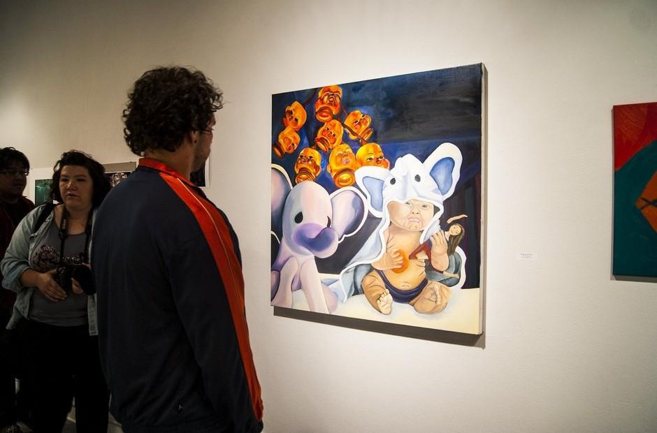 A man looking at a student painting.