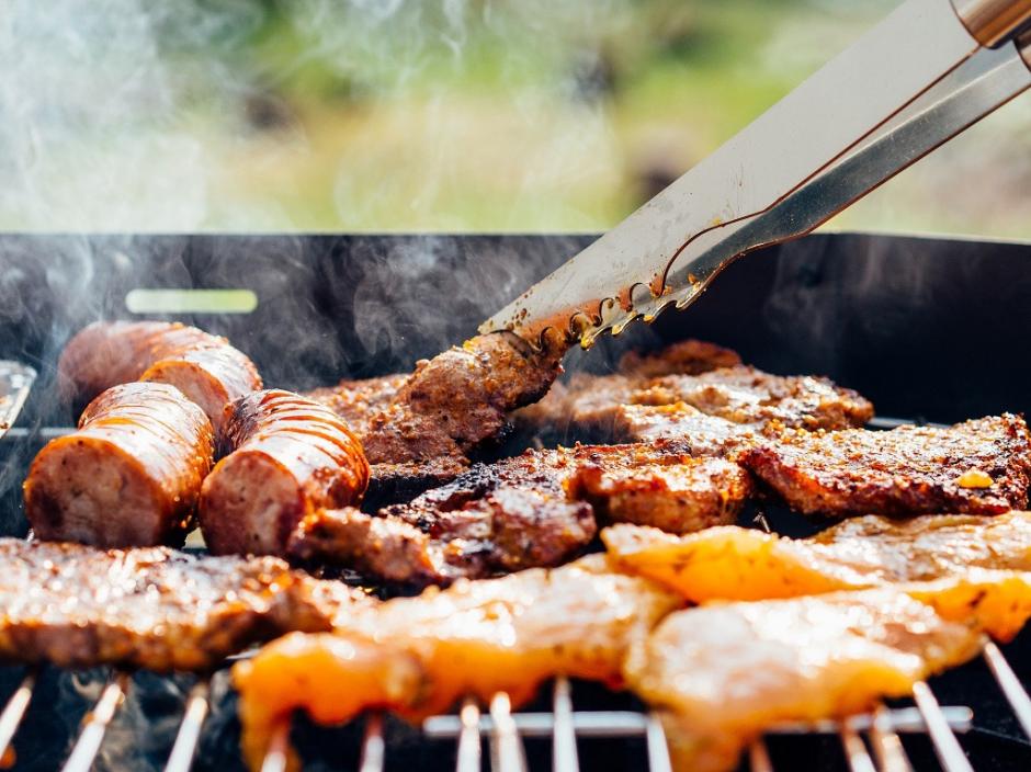 A BBQ grill with food.
