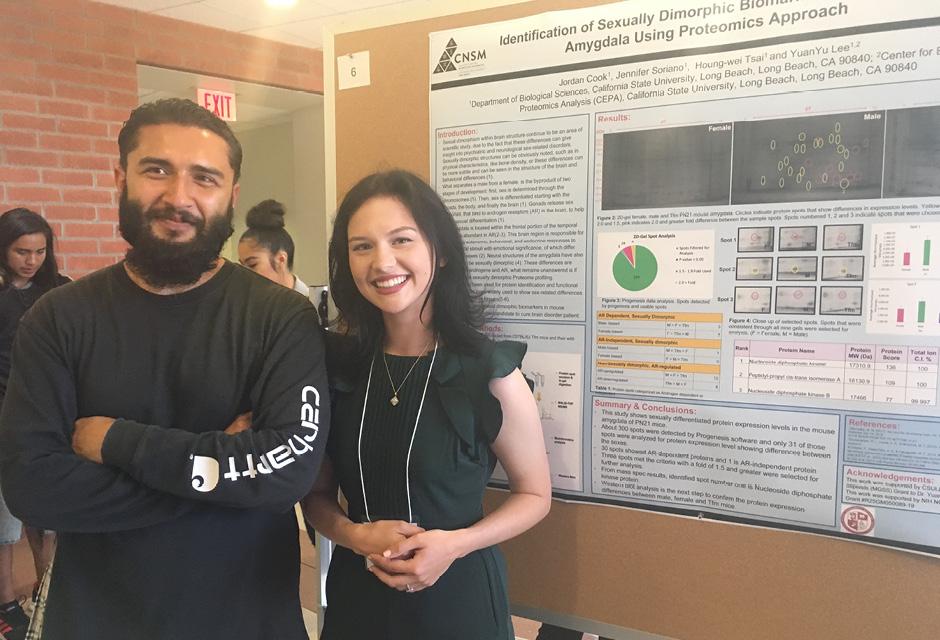 2 LBCC students standing next to their science research board at Bridges to the Baccalaureate Program