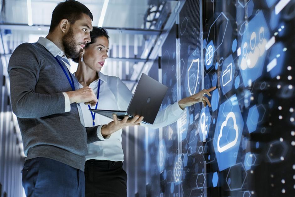 Workers in server room developing database systems