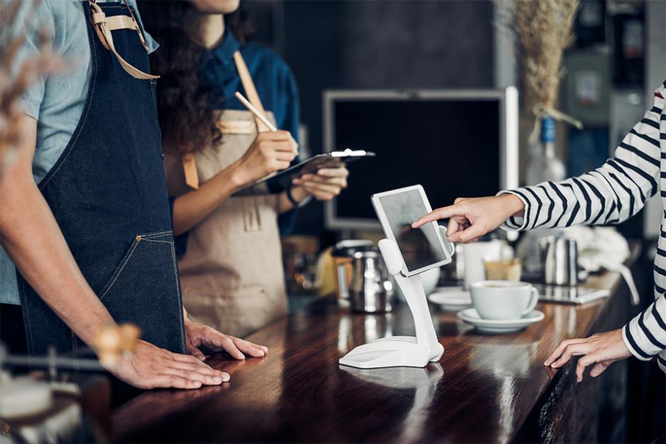 Customer self service paying at the counter with ipad