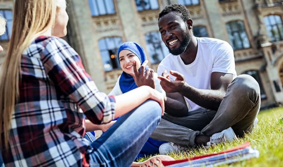 Extremely happy college students enjoying pleasant conversation on University campus