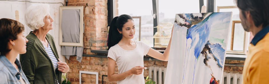 Artist explaining her art in a studio
