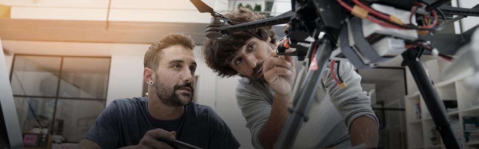 Two students working on a machine