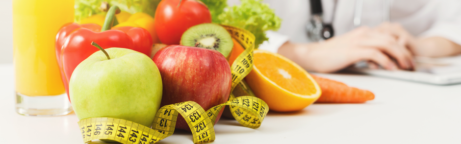 Nutritionist desk with fruit and measuring tape
