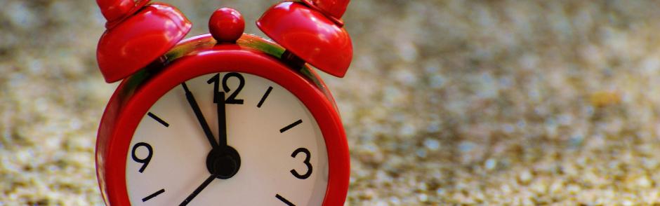 A clock on a sandy beach.