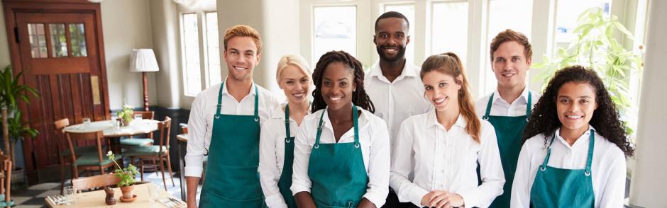 Portrait Of Restaurant Team Standing In Empty Dining Room