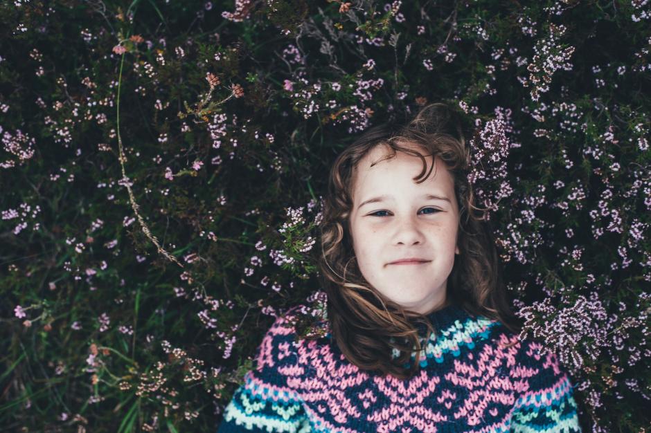 A child laying on flower field