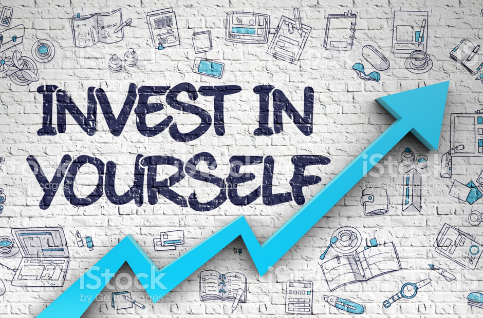The words "Invest In Yourself" written on a wall.