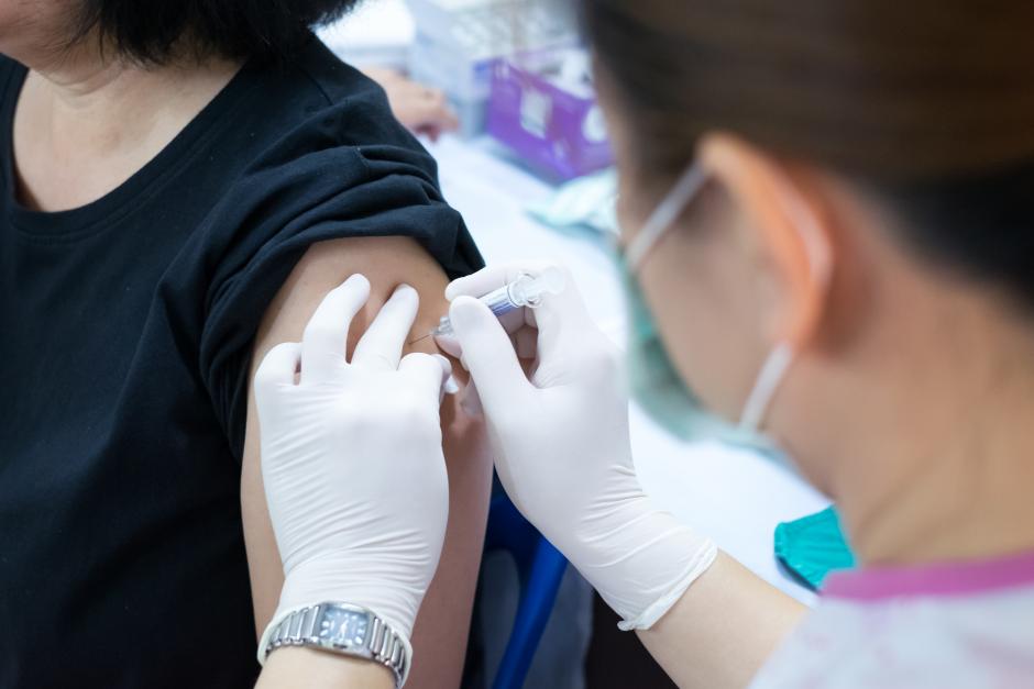 Nurse giving flu shot to a person