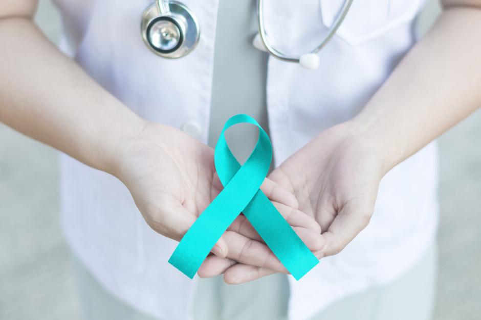 Teal ribbon awareness on doctor's hand for sexual assault awareness 