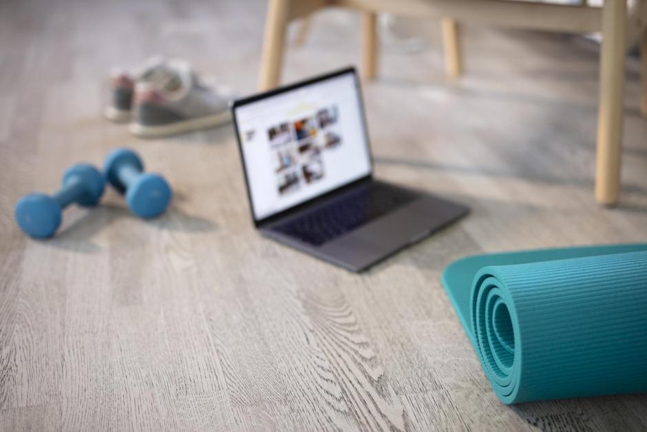 Preparing for training online. Mat, dumbbell, mat and laptop. Preparing for online fitness training at home with laptop and fitness mat