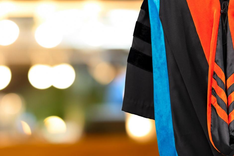 PhD graduate in black gown University bachelor degree