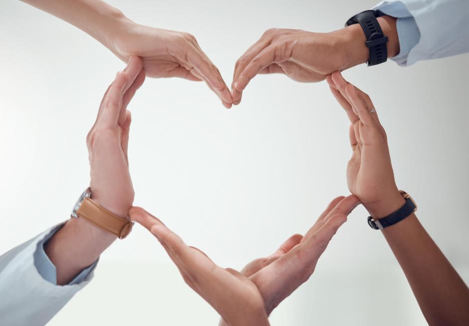 Hands make heart shape on a white background