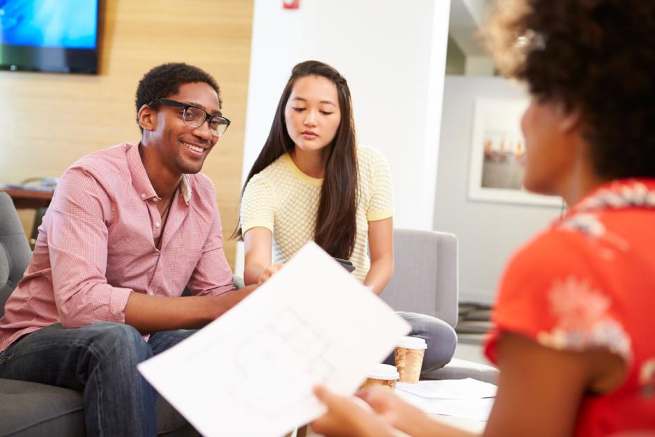 a group of three happy students or colleagues