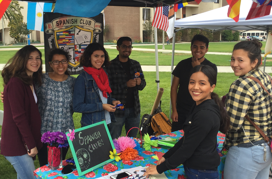 Students standing in front of the Spanish Club table.