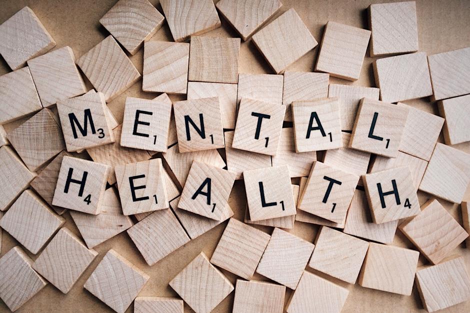 Wood blocks on table with Mental health text written on some.