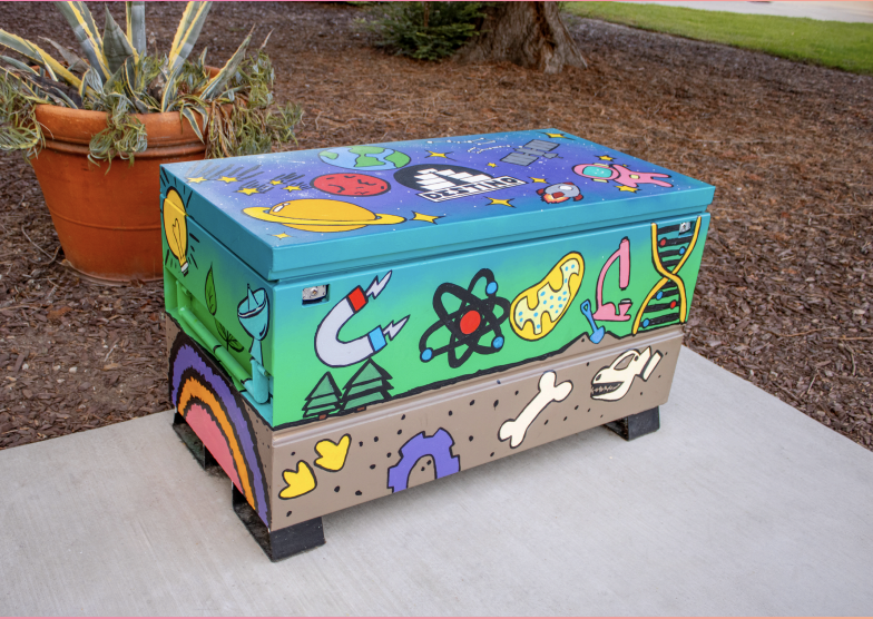 Box painted in multiple colors with math and science symbols
