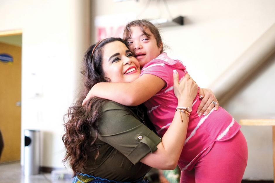 teacher hugging student with down syndrome