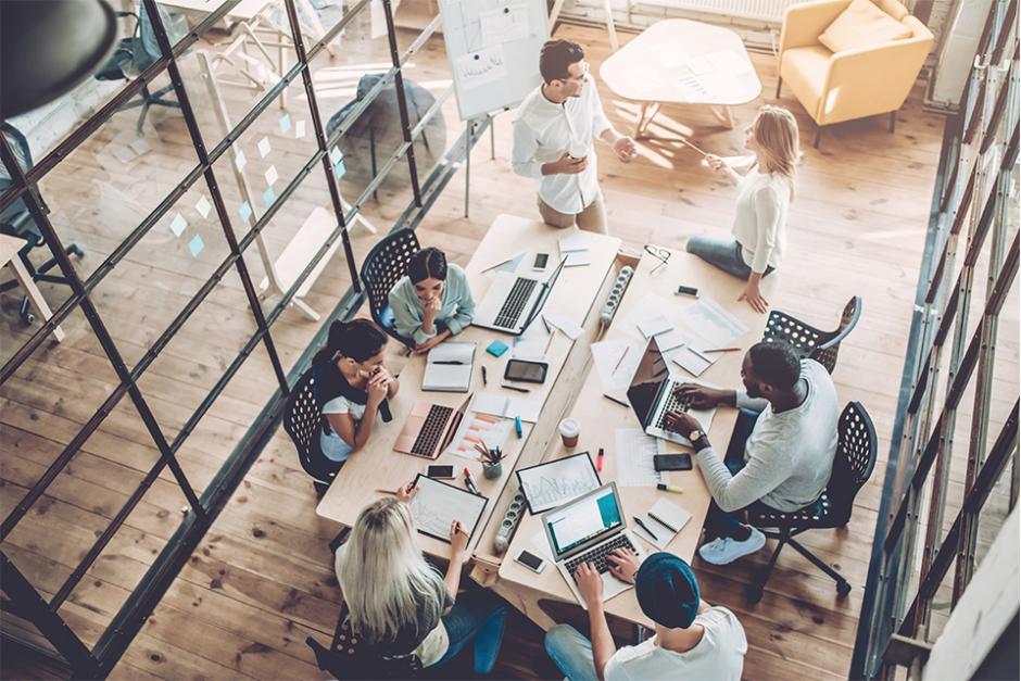 An office with business administrators communicating with each other