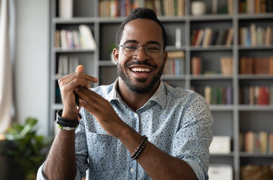 A young, black professional wearing glasses.