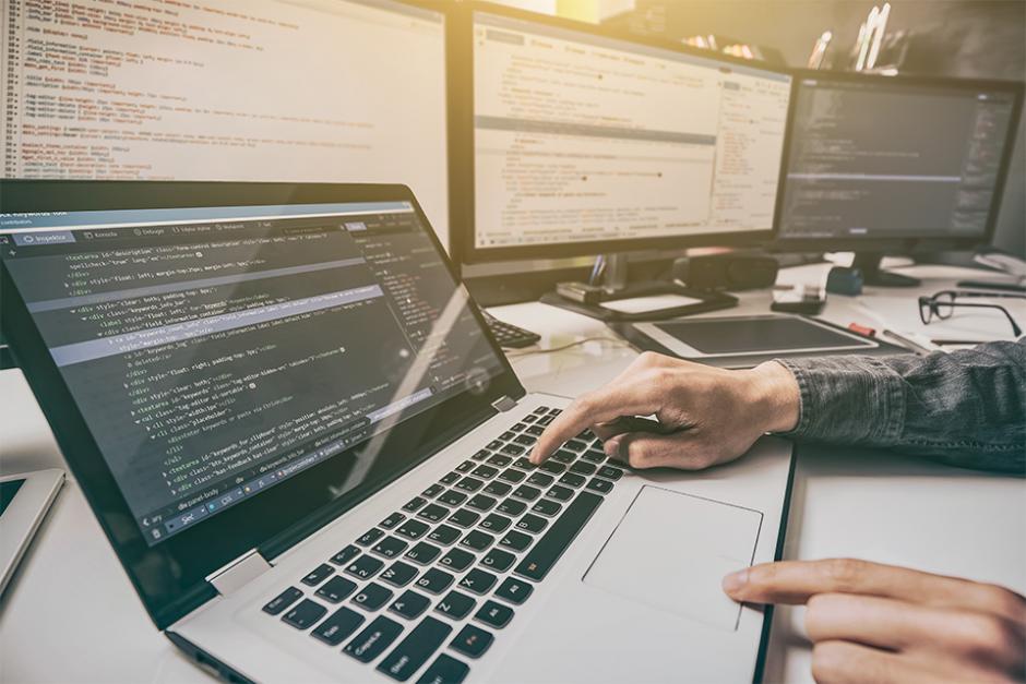 A person working on codings and web development with computers 