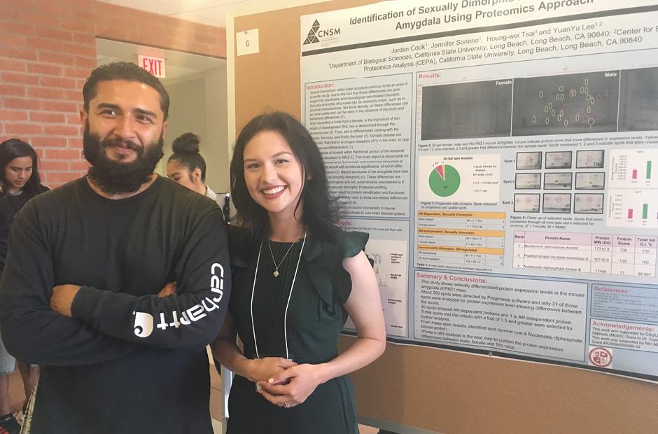 2 LBCC students standing next to their science research board at Bridges to the Baccalaureate Program