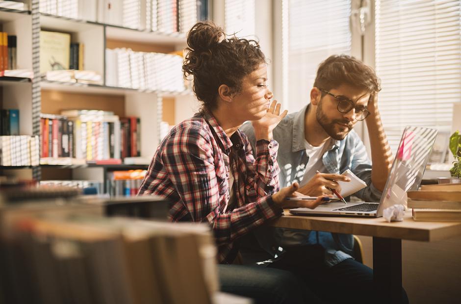 Students preparing for documents in a library