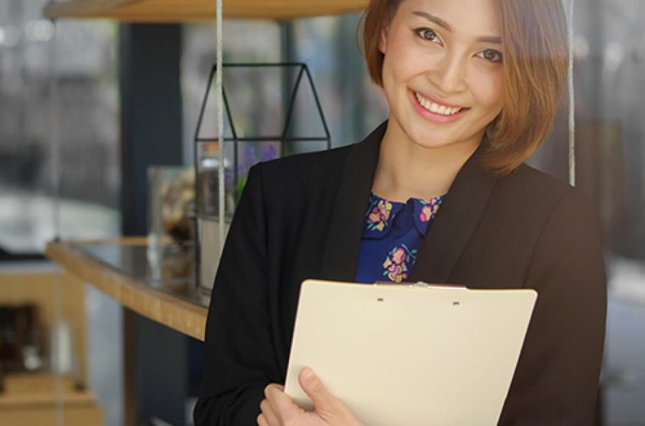 Secretary woman holding a document file and smile on face