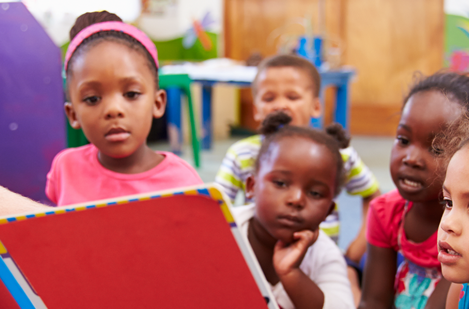 Male teacher reading to children