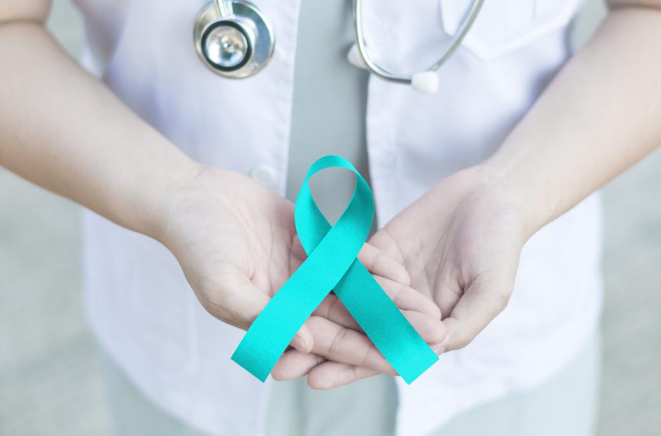 Teal ribbon awareness on doctor's hand for sexual assault awareness 