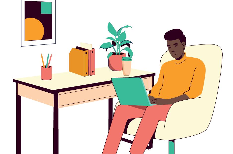 A young black man works on a laptop on an armchair at home office.