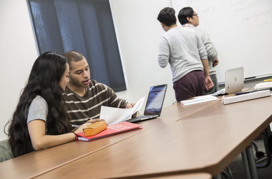 Students helping each other study.