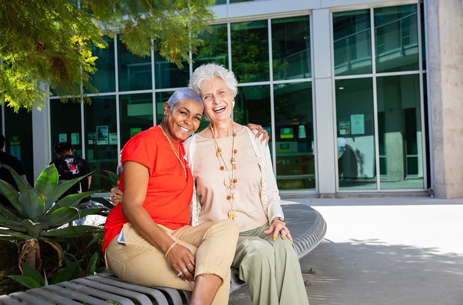 2 women sitting outside of LBCC PCC campus