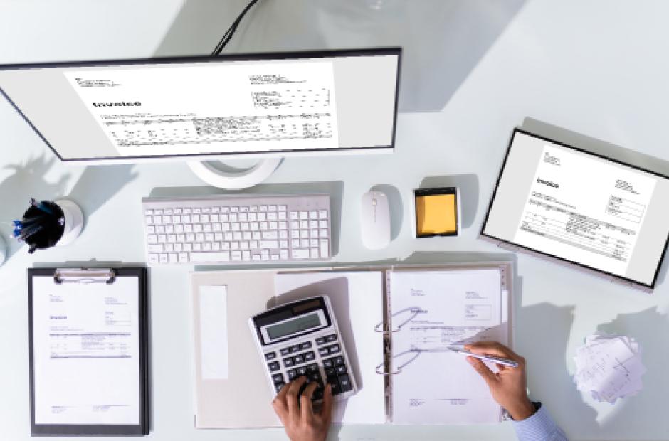 laptop, cash, calculator, and spreadsheets on the table. Accounting concept.