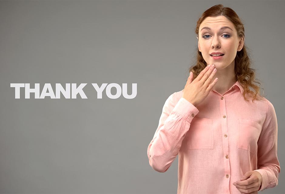 Woman saying thank you in sign language