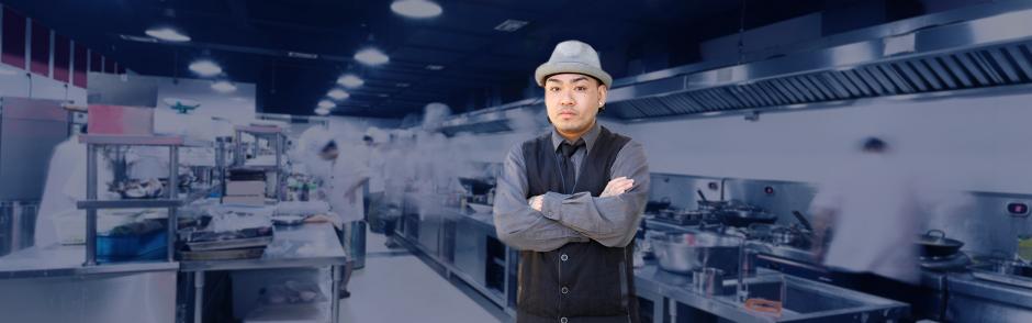 A picture of Chef T standing in a restaurant kitchen.