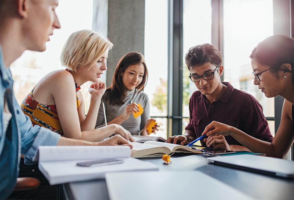Diverse group of students studying at library 