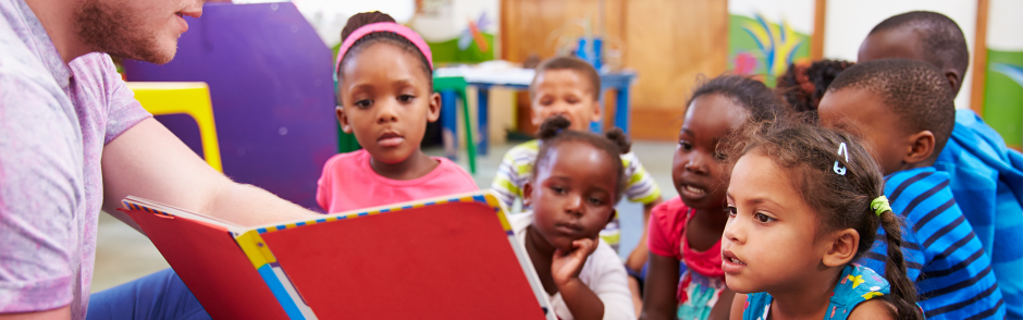 Male teacher reading to children