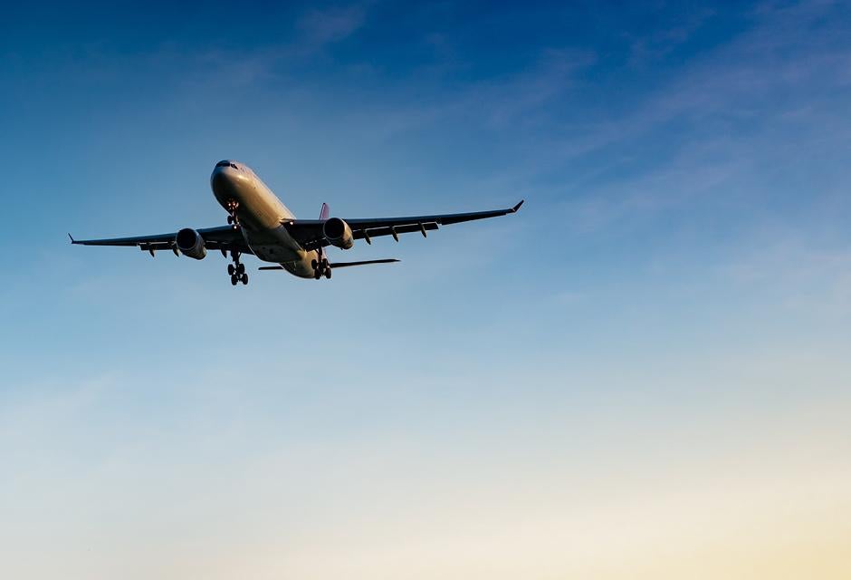 Commercial airline. Passenger plane landing at airport with beautiful blue sky and white clouds. Arrival flight. Welcome tourist from overseas. Vacation time. Happy trip. Airplane flying on bright sky