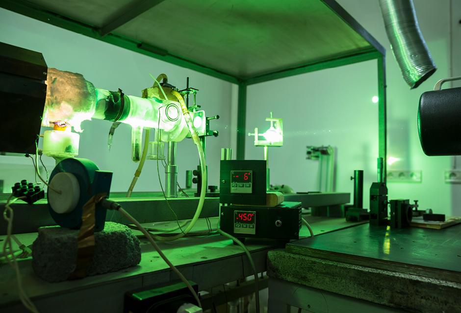 Powerful industrial green laser equipment in a laboratory for physics research. Solid State Physics lab. Light amplification by stimulated emission of radiation (LASER).