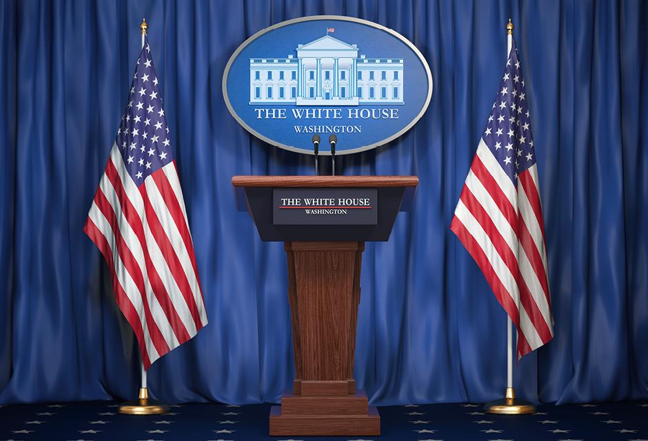 Briefing of president of US United States in White House. Podium speaker tribune with USA flags and sign of White Houise. Politics concept.