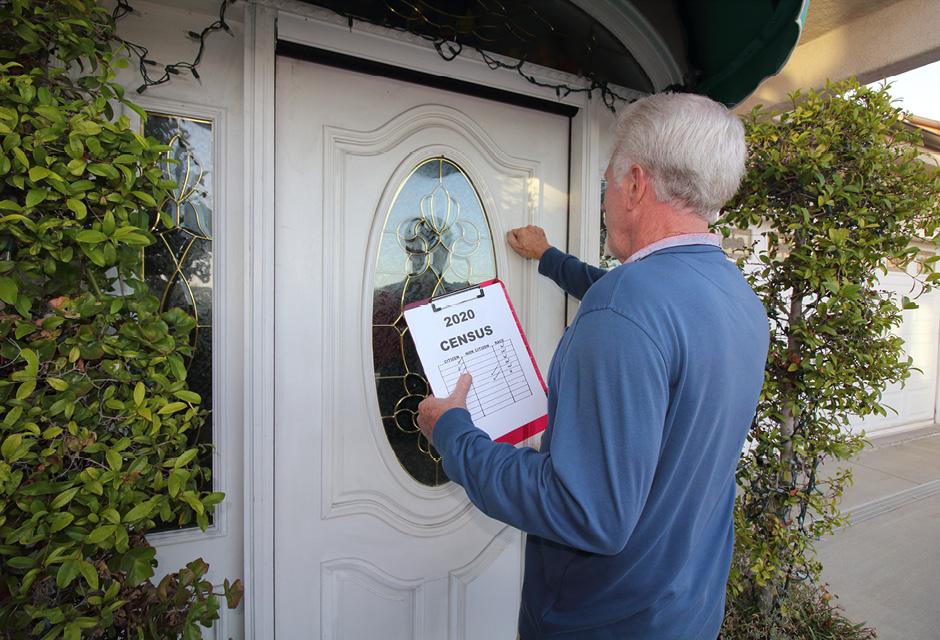 A man going door to door collecting information for the 2020 census
