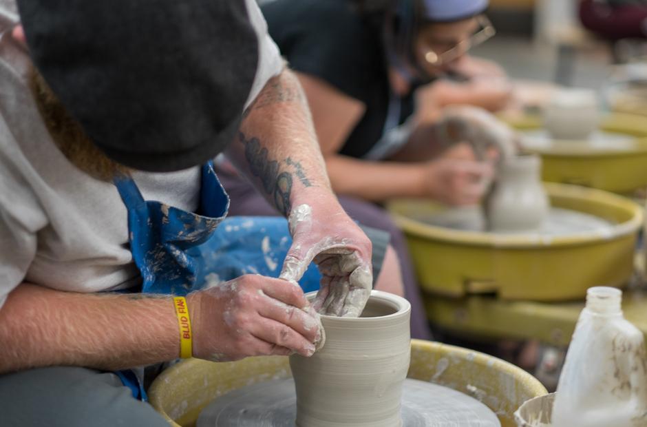 A student a vase on a spinning wheel.