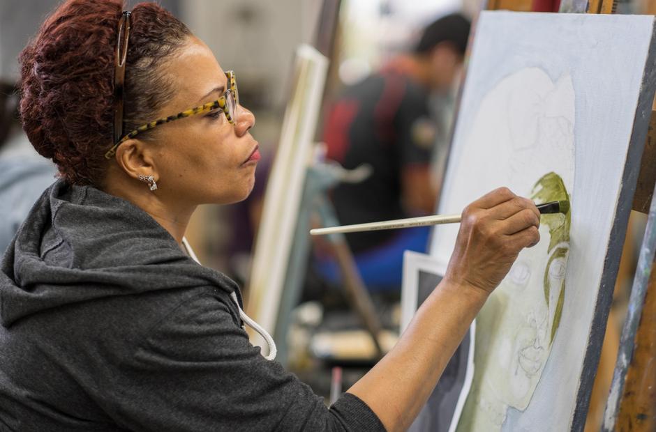 A student painting a portrait.